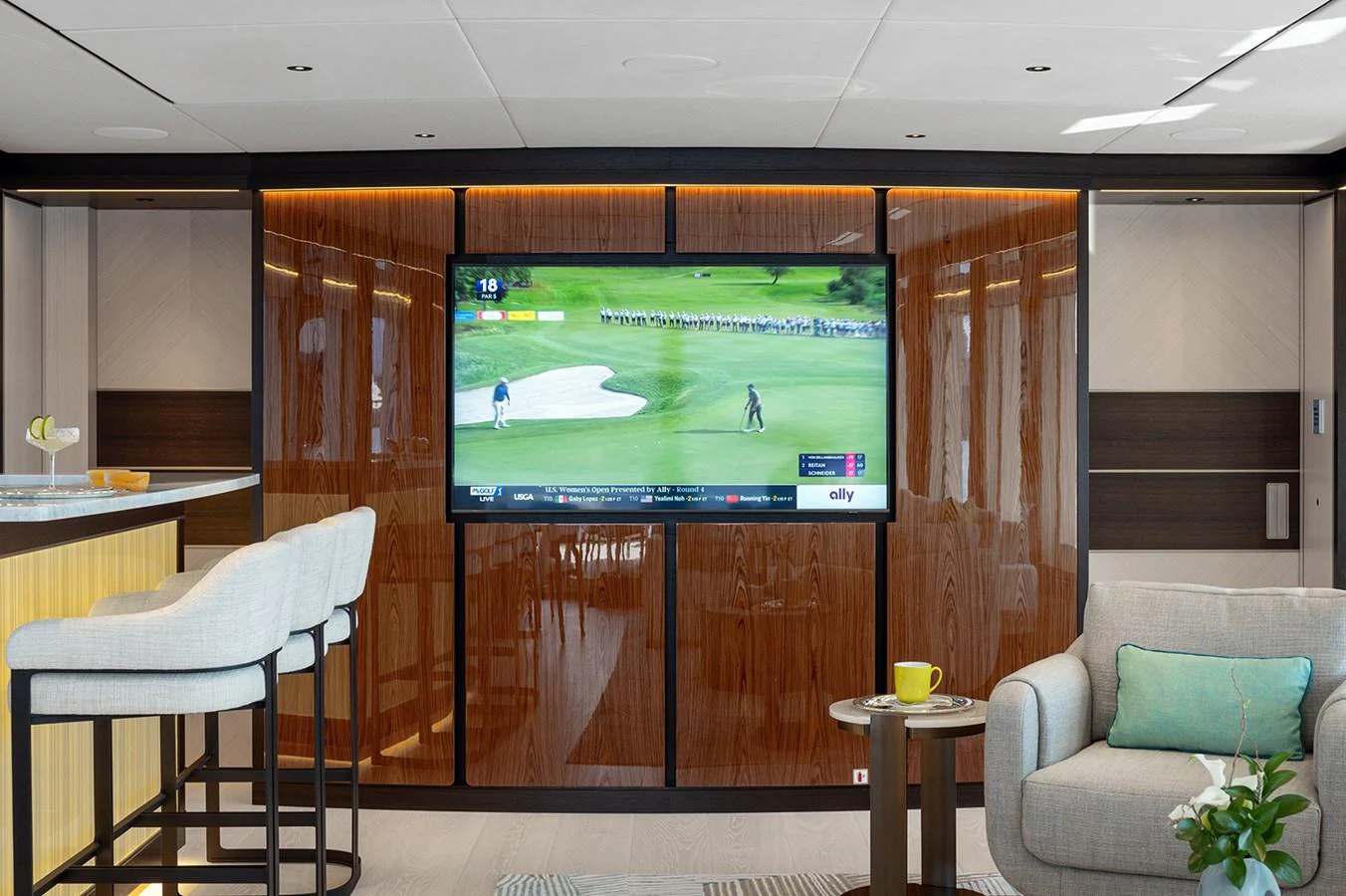 The yacht's salon features a comfortable seating area with a large television and a stylish bar. aboard SOLEMATES Yacht for Sale
