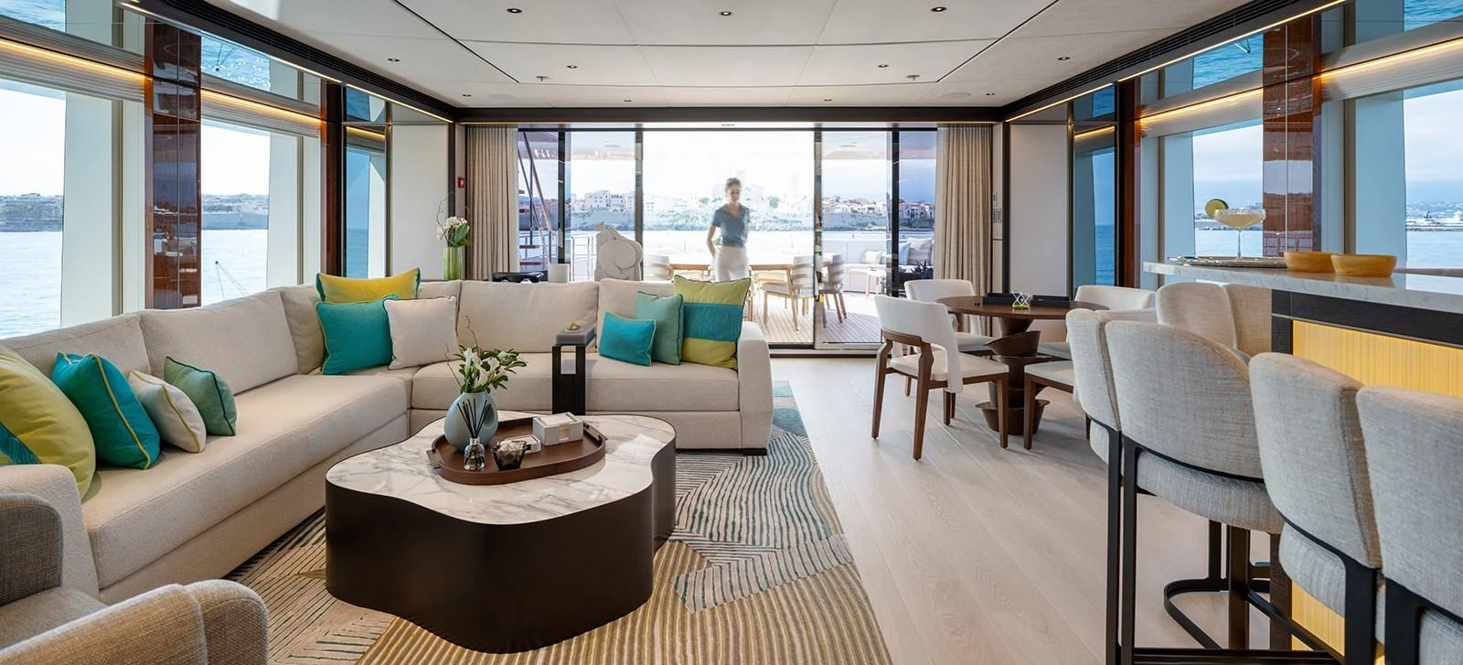 The salon offers a spacious and elegant living area with panoramic views and luxurious furnishings. aboard SOLEMATES Yacht for Sale
