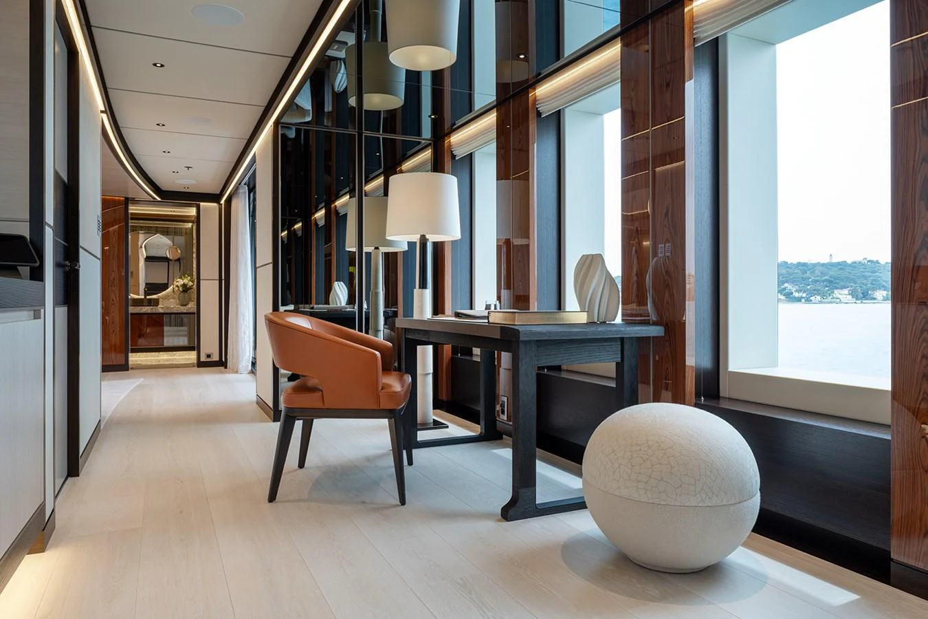 A stylish and modern interior space featuring elegant furnishings and large windows with scenic views. aboard SOLEMATES Yacht for Sale
