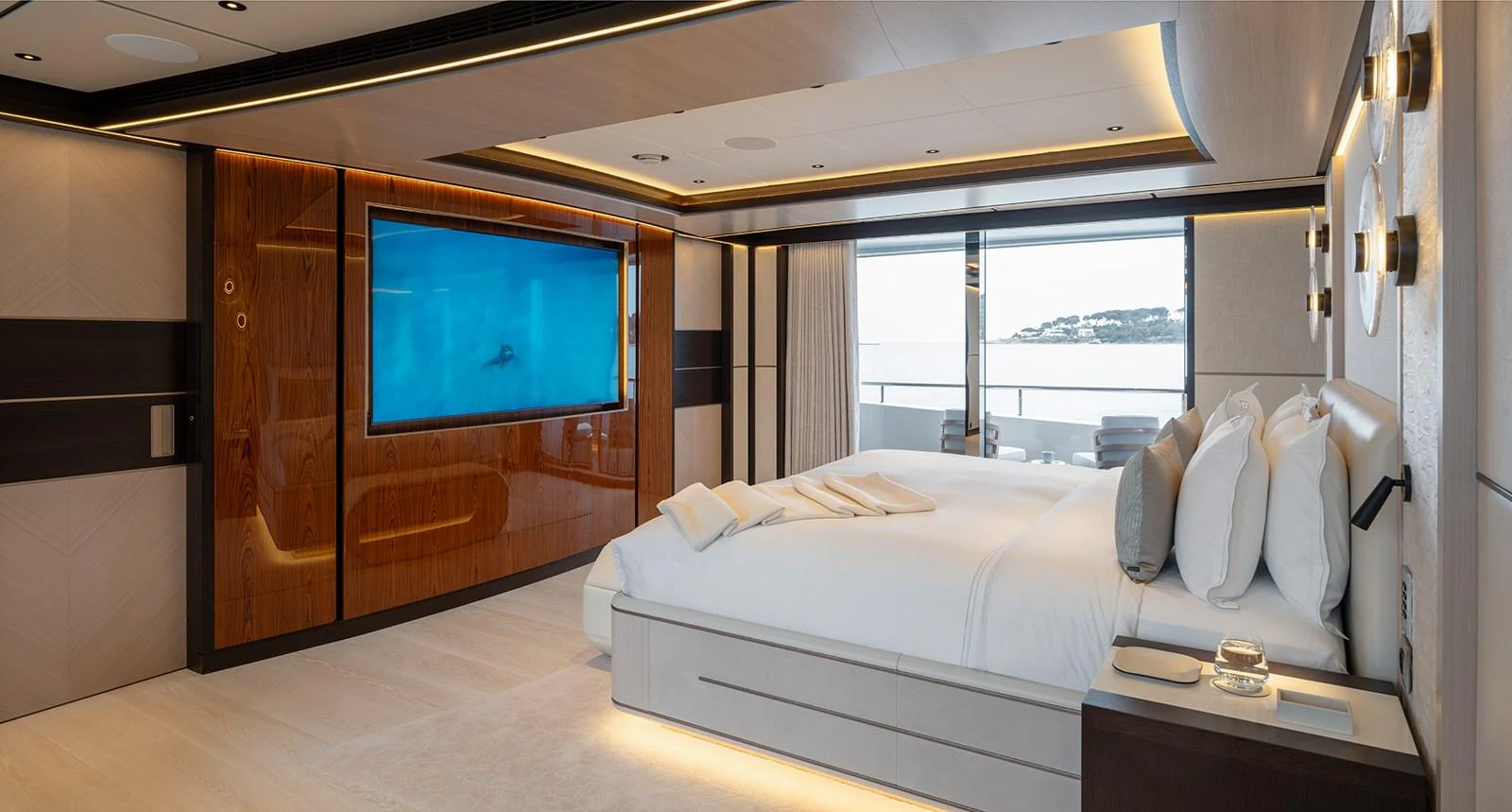 The master stateroom features a luxurious bed, a large TV, and a private balcony with stunning views. aboard SOLEMATES Yacht for Sale