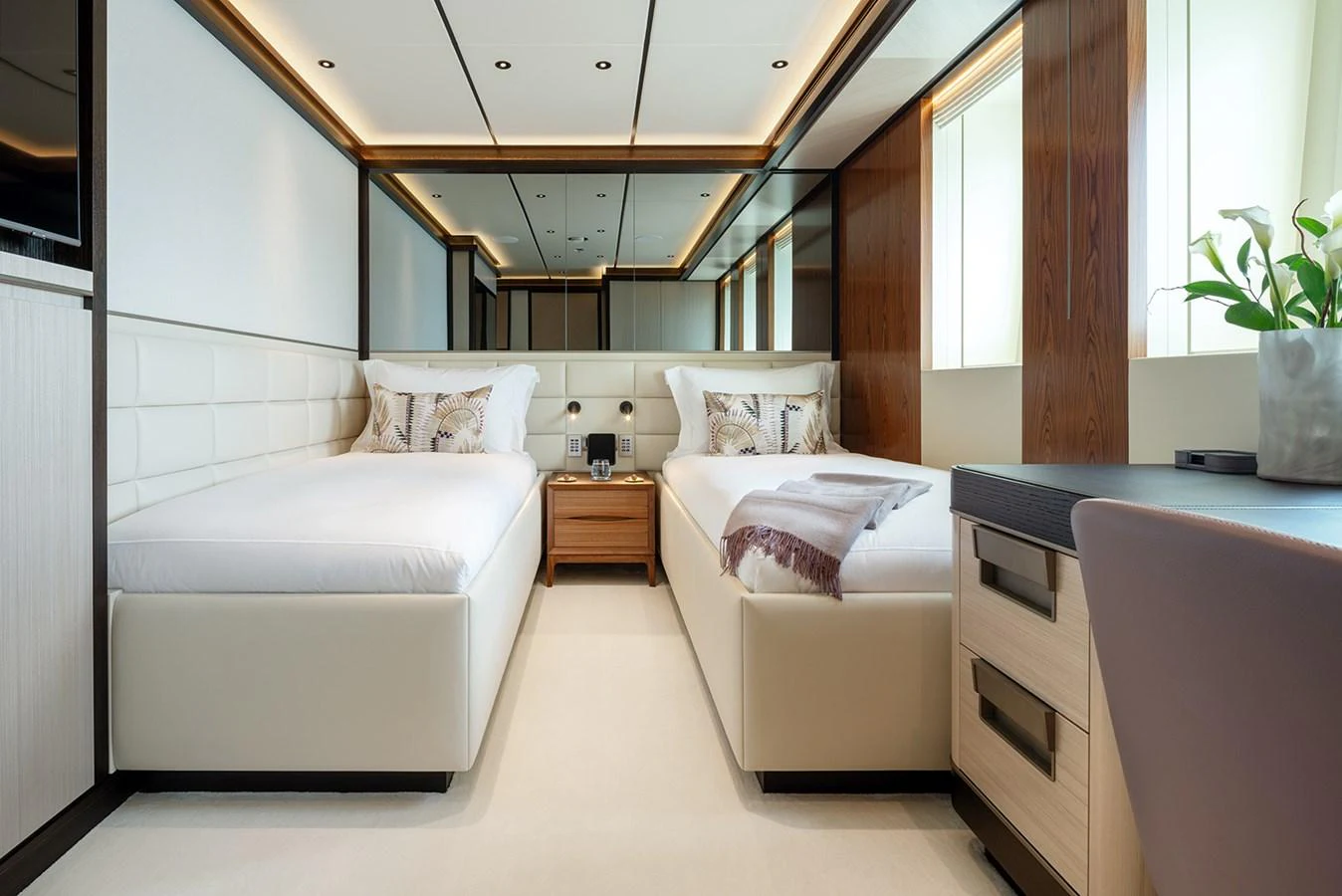 The twin stateroom features elegant decor with plush bedding and ample natural light. aboard SOLEMATES Yacht for Sale