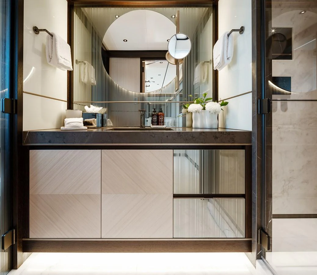 The yacht's bathroom features a modern design with elegant fixtures and a large mirror. aboard SOLEMATES Yacht for Sale