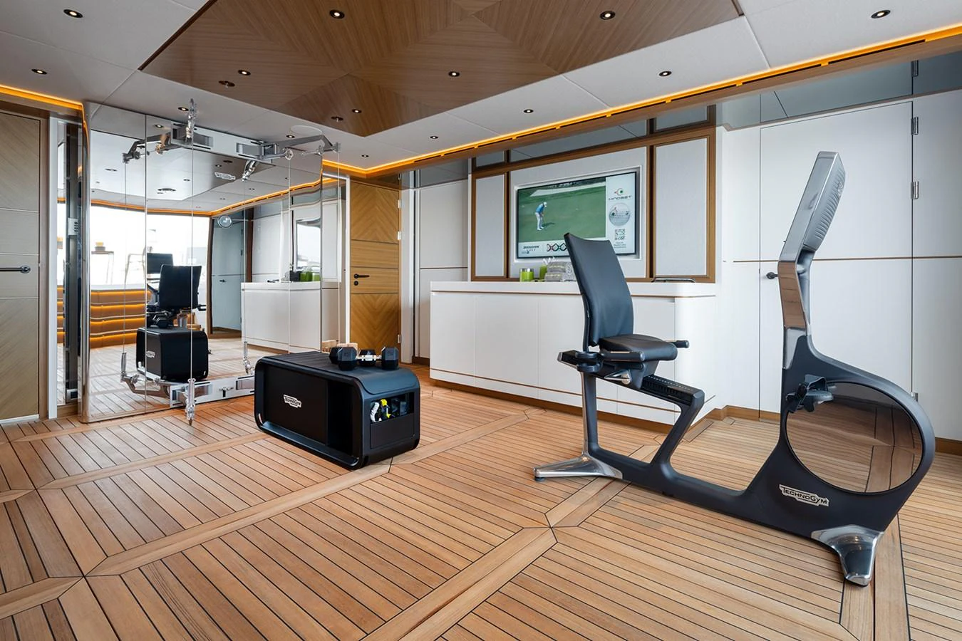 The yacht's gym features modern fitness equipment and a sleek, spacious design. aboard SOLEMATES Yacht for Sale