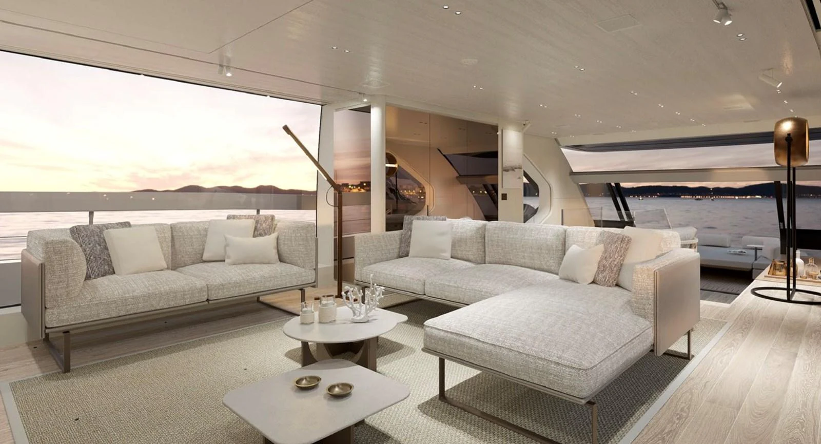 The salon features luxurious seating with a stunning view of the sunset over the water. aboard SP92 Yacht for Sale