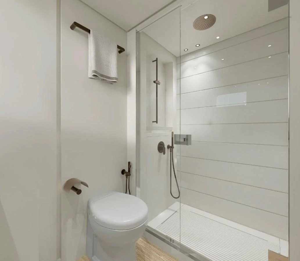 A sleek and modern yacht bathroom with a glass-enclosed shower and elegant fixtures. aboard SP92 Yacht for Sale