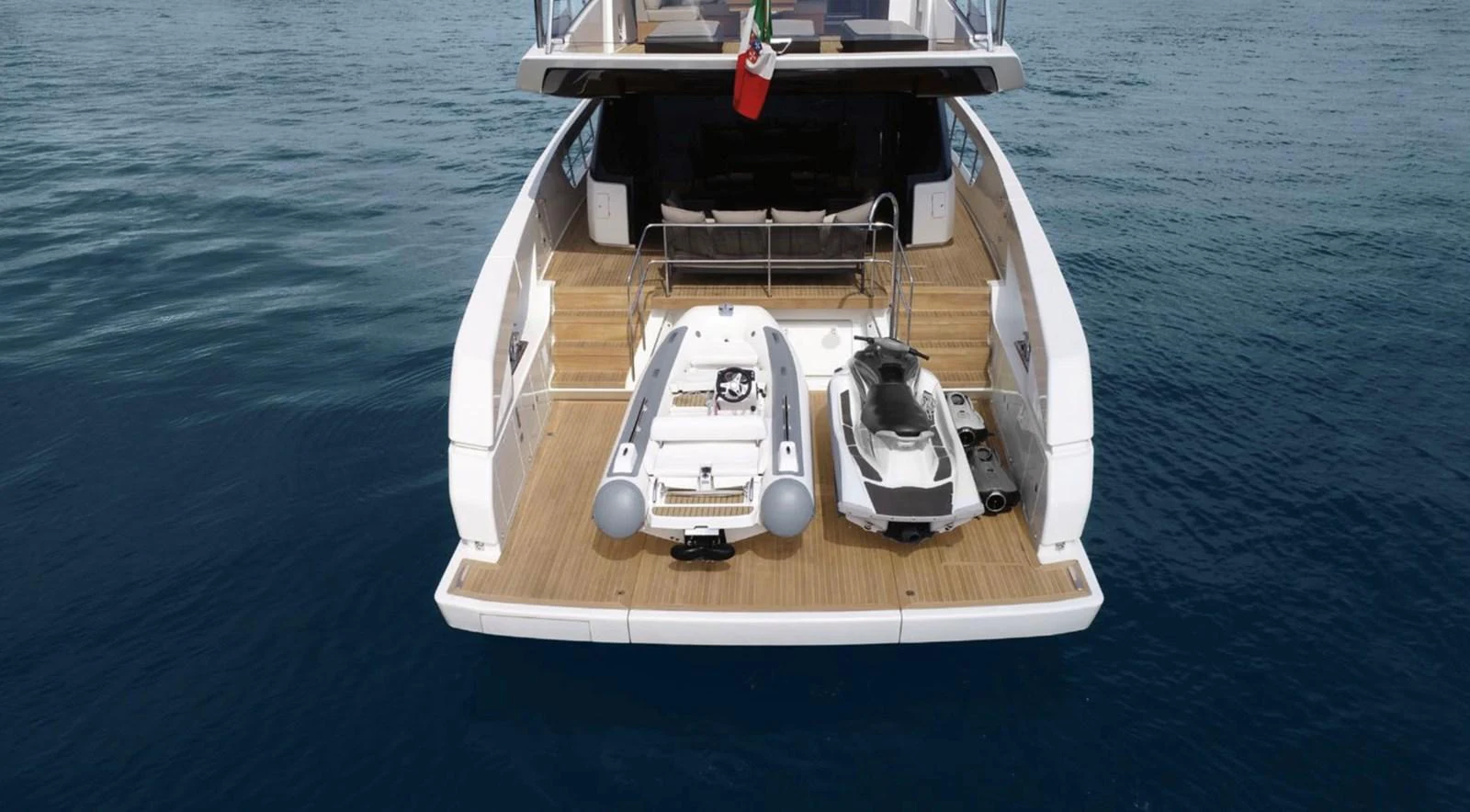 The yacht's aft deck features a tender and a jet ski, ready for water adventures. aboard SX76 Yacht for Sale