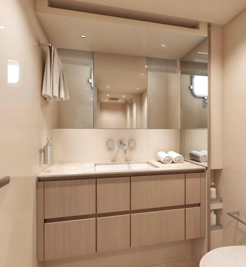 A sleek and modern yacht bathroom with a large mirror and ample storage. aboard SX76 Yacht for Sale