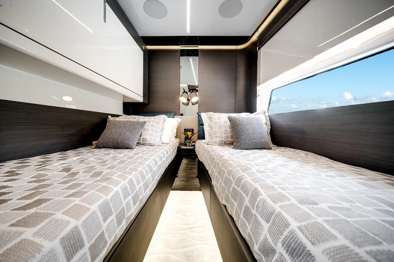The guest stateroom features twin beds with modern decor and ample natural light. aboard PARTNERSHIP V Yacht for Sale