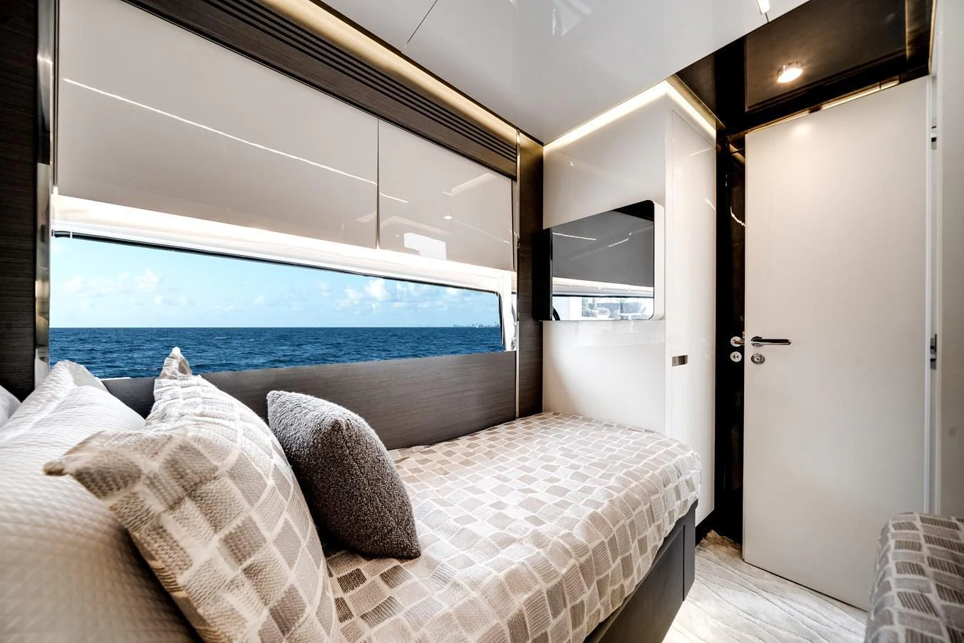 A cozy stateroom with a large window offering a stunning ocean view. aboard PARTNERSHIP V Yacht for Sale