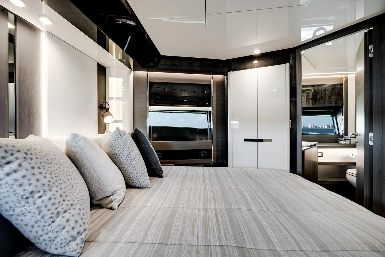 The stateroom features a luxurious bed with plush pillows and modern decor. aboard PARTNERSHIP V Yacht for Sale