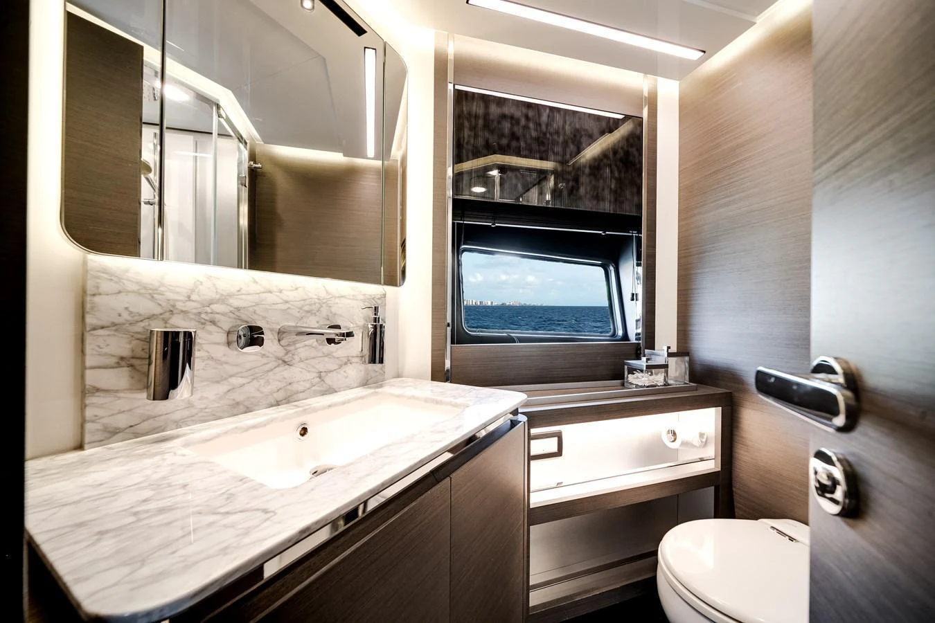 The yacht's bathroom features modern fixtures and a sleek design with a view of the sea. aboard PARTNERSHIP V Yacht for Sale