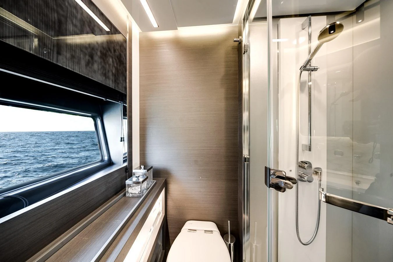 A sleek and modern yacht bathroom with a large window offering a view of the sea. aboard PARTNERSHIP V Yacht for Sale
