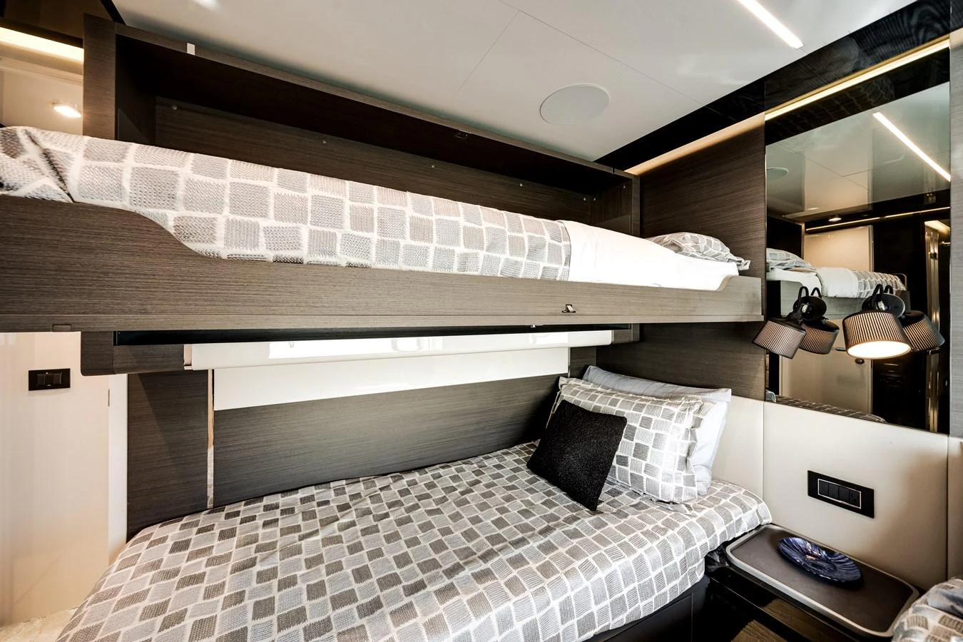 The guest cabin features a cozy bunk bed setup with modern decor and ample lighting. aboard PARTNERSHIP V Yacht for Sale