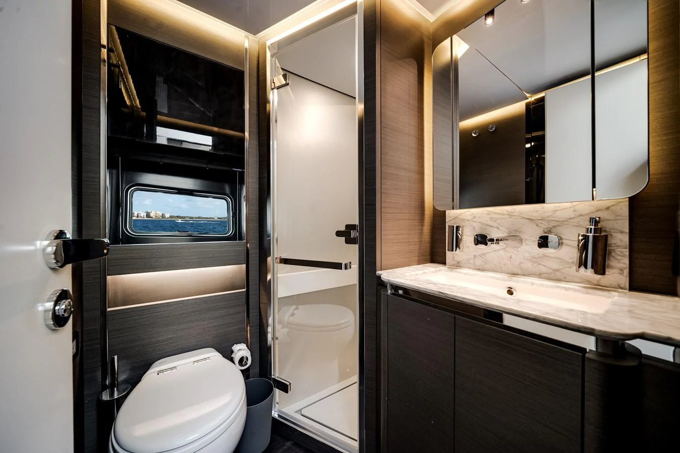 The yacht's bathroom features modern fixtures and a sleek design with a view of the sea through the window. aboard PARTNERSHIP V Yacht for Sale