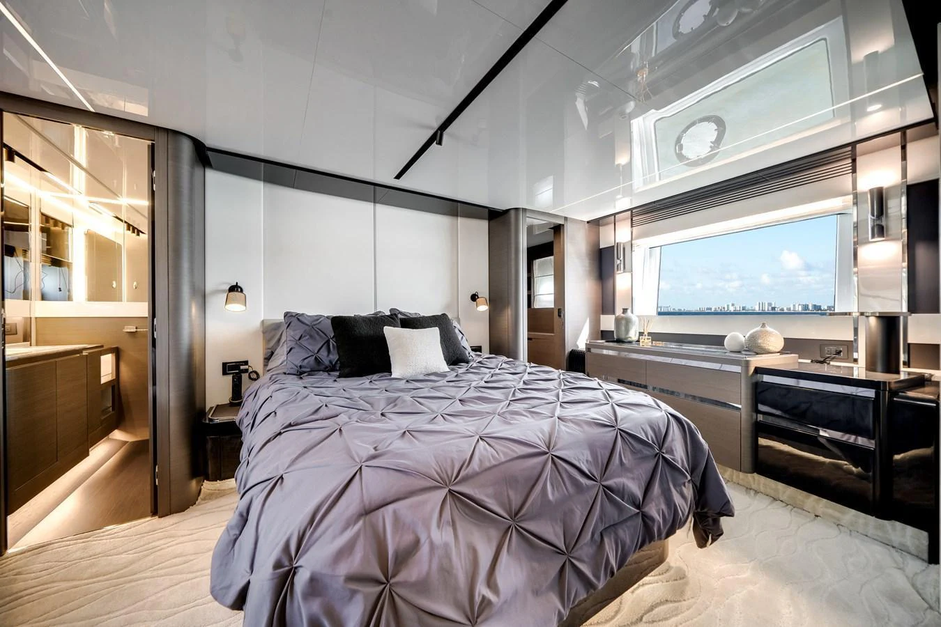 The stateroom features a luxurious bed with elegant bedding and ample natural light from large windows. aboard PARTNERSHIP V Yacht for Sale