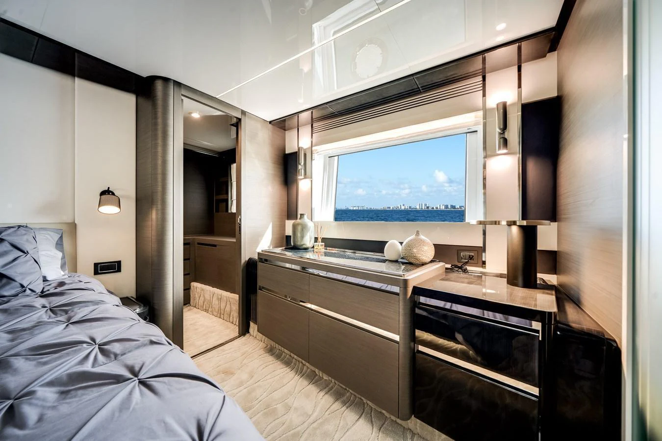 The stateroom features a luxurious bed, modern cabinetry, and a large window offering stunning sea views. aboard PARTNERSHIP V Yacht for Sale