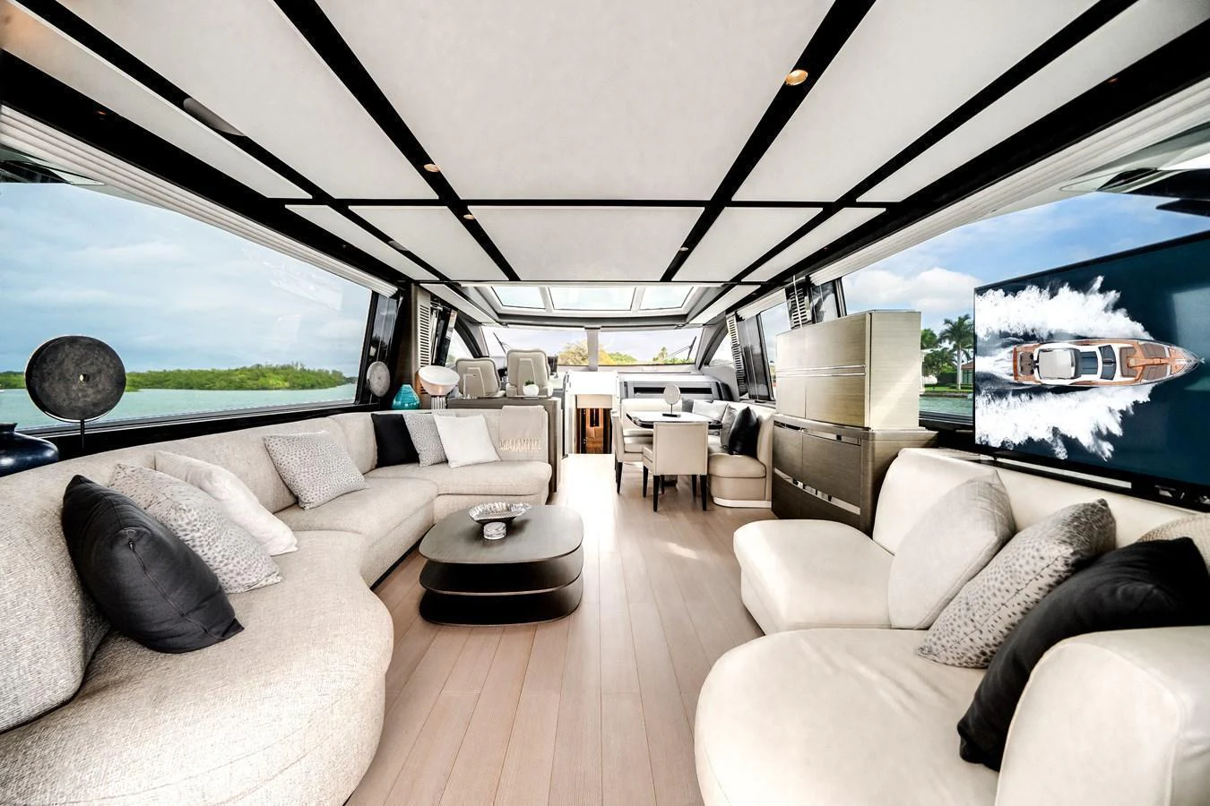 The spacious salon features modern furnishings and expansive windows for panoramic views. aboard PARTNERSHIP V Yacht for Sale