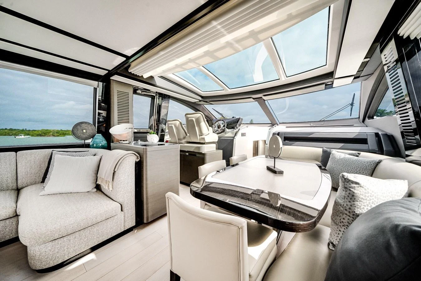 The salon features a spacious and modern design with ample natural light from large windows and a skylight. aboard PARTNERSHIP V Yacht for Sale
