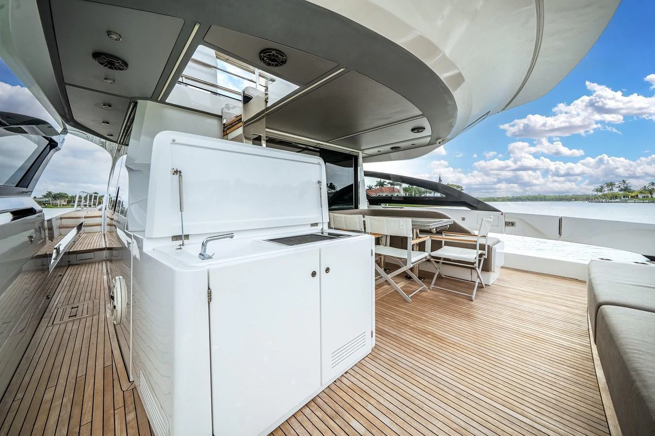 The aft deck features a spacious seating area and a convenient wet bar, perfect for outdoor relaxation and entertainment. aboard PARTNERSHIP V Yacht for Sale
