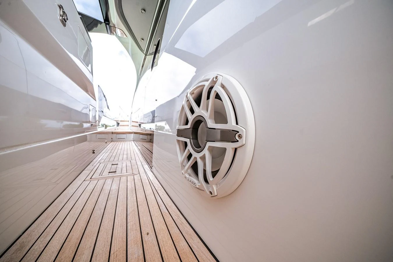 A close-up view of a yacht's exterior speaker system and teak deck. aboard PARTNERSHIP V Yacht for Sale