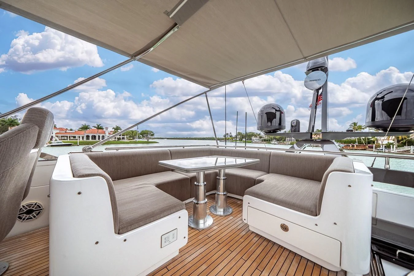 The aft deck features a comfortable seating area with a table, perfect for outdoor dining and relaxation. aboard PARTNERSHIP V Yacht for Sale
