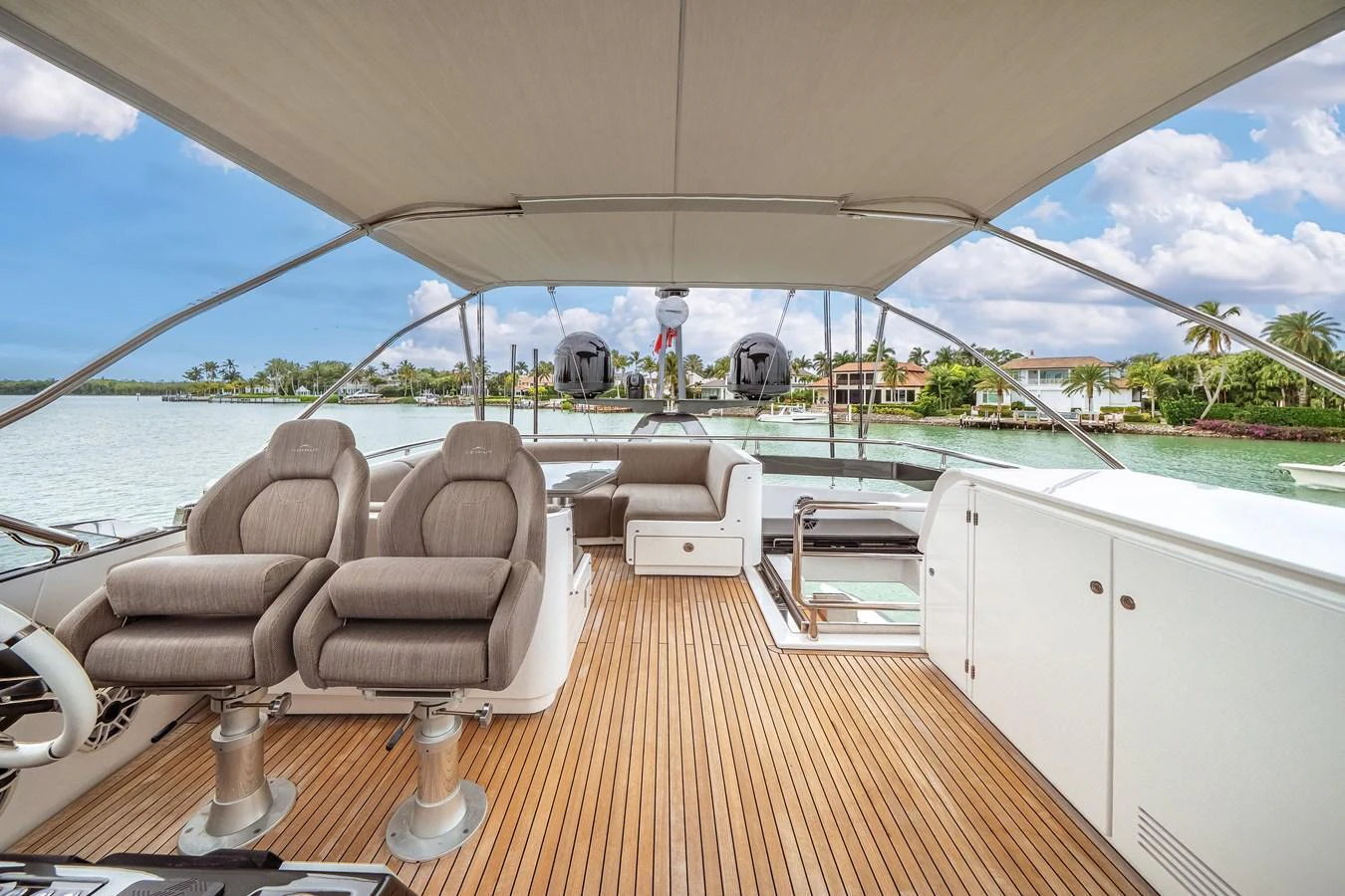 The flybridge offers a spacious and luxurious outdoor area with comfortable seating and stunning views. aboard PARTNERSHIP V Yacht for Sale