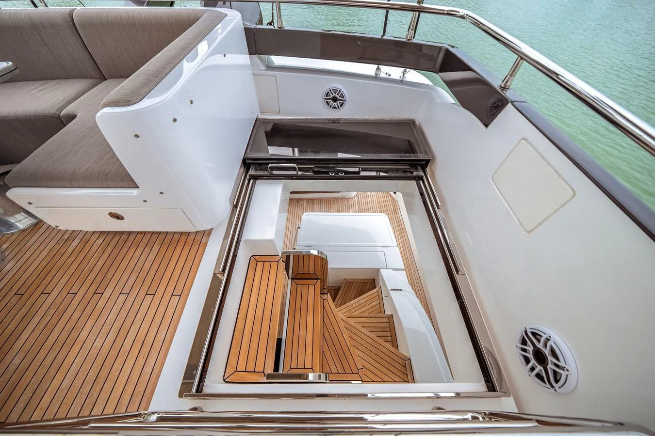A view of the yacht's staircase leading down from the deck, showcasing elegant woodwork and modern design. aboard PARTNERSHIP V Yacht for Sale