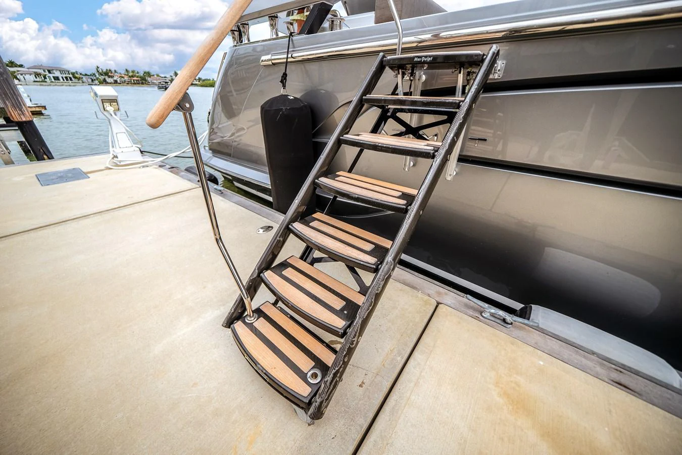 A sleek and sturdy boarding ladder provides easy access to the yacht from the dock. aboard PARTNERSHIP V Yacht for Sale