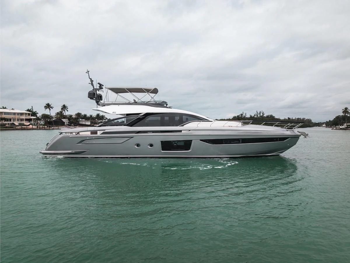 A sleek, modern yacht glides gracefully on calm waters under a cloudy sky. aboard PARTNERSHIP V Yacht for Sale