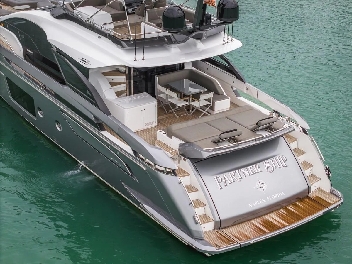 The yacht's aft deck features a stylish seating area and a swim platform, perfect for relaxation and water activities. aboard PARTNERSHIP V Yacht for Sale