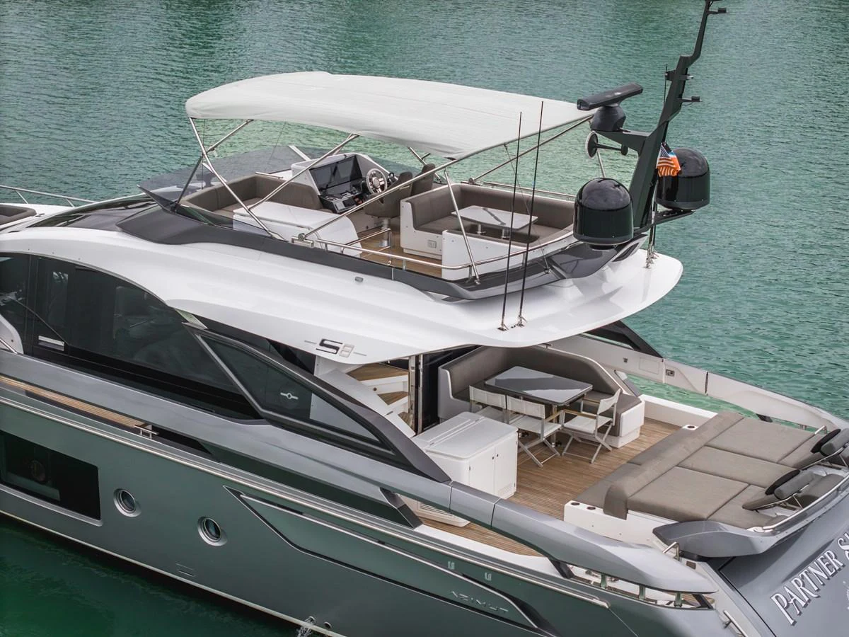 This sleek yacht features a spacious aft deck with comfortable seating and a modern design. aboard PARTNERSHIP V Yacht for Sale