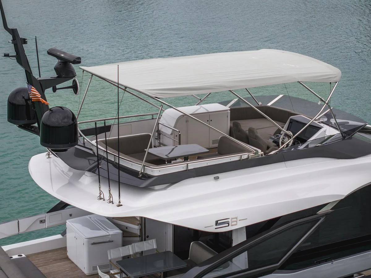 The yacht's flybridge offers a shaded seating area with a sleek, modern design. aboard PARTNERSHIP V Yacht for Sale