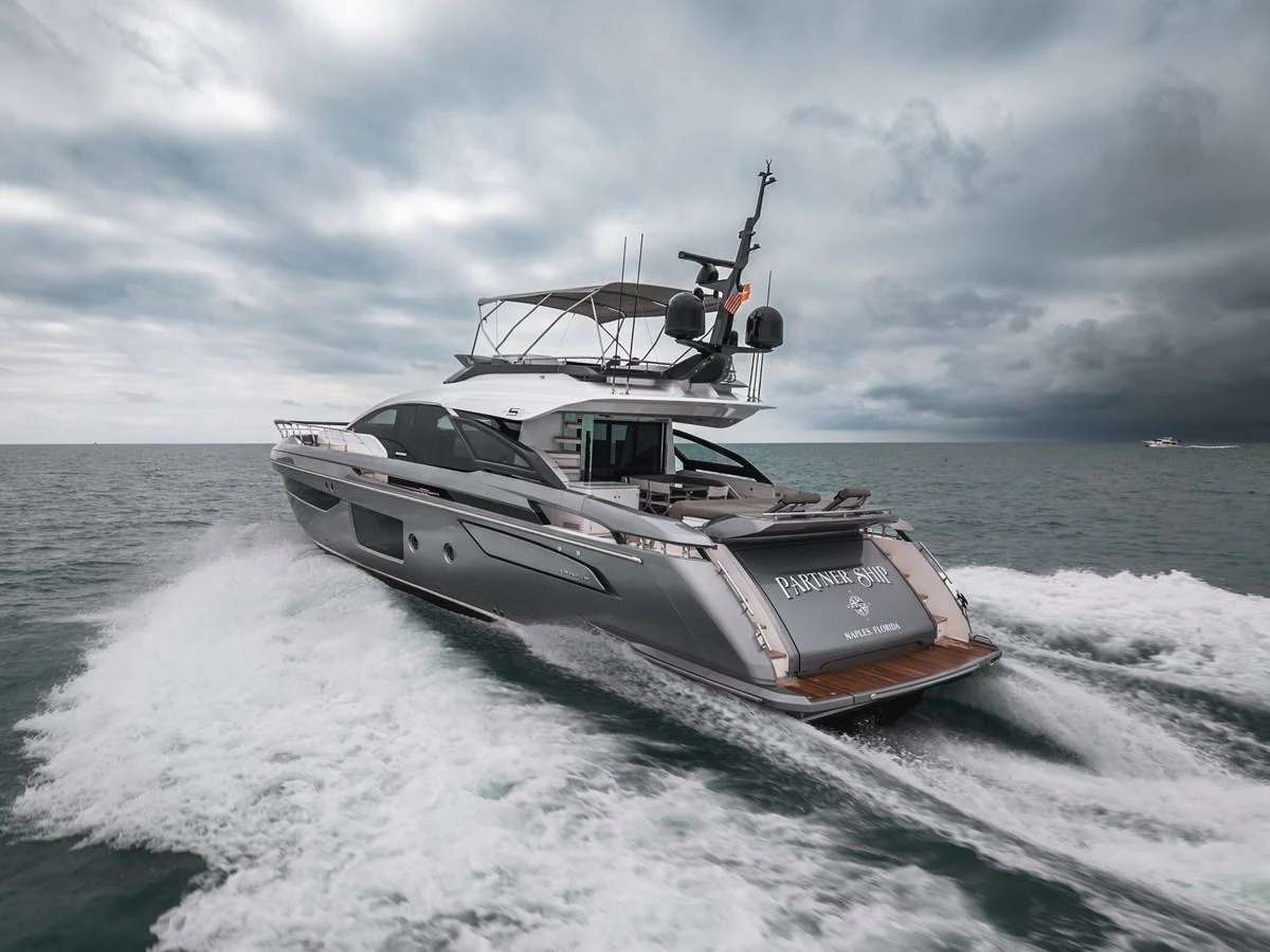 A sleek yacht cruises through the water, showcasing its modern design and powerful performance. aboard PARTNERSHIP V Yacht for Sale