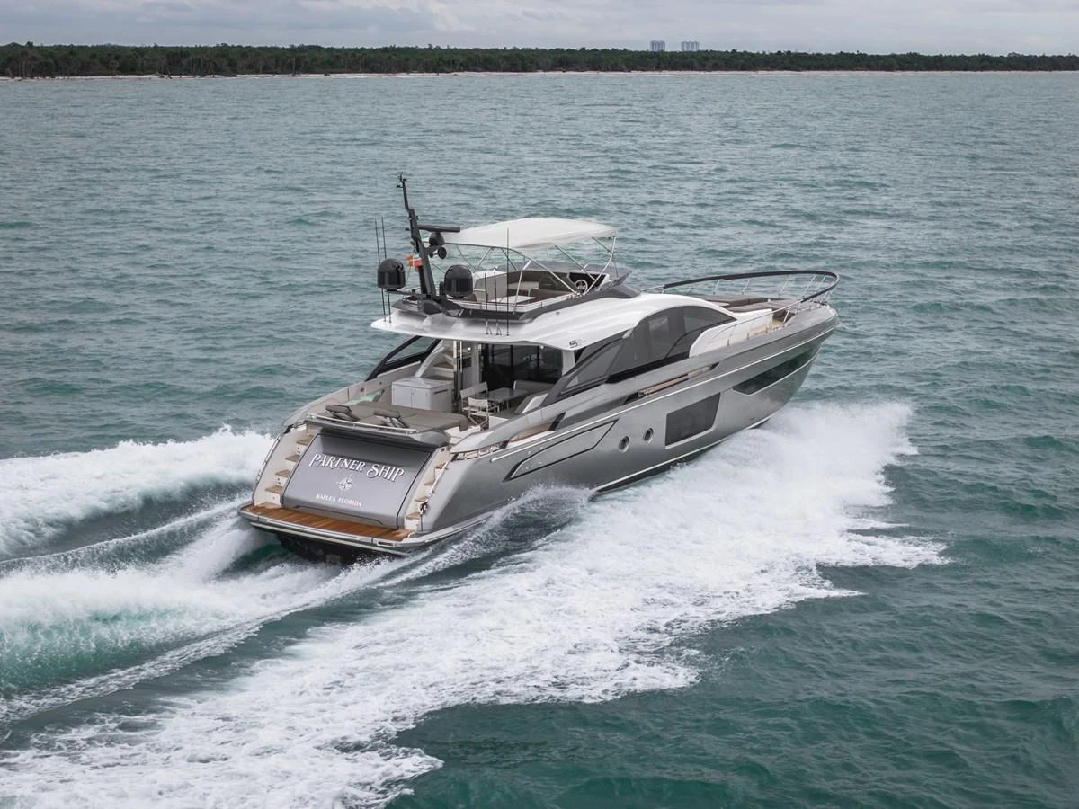 A sleek and modern yacht cruises swiftly through the water, showcasing its elegant design and powerful performance. aboard PARTNERSHIP V Yacht for Sale