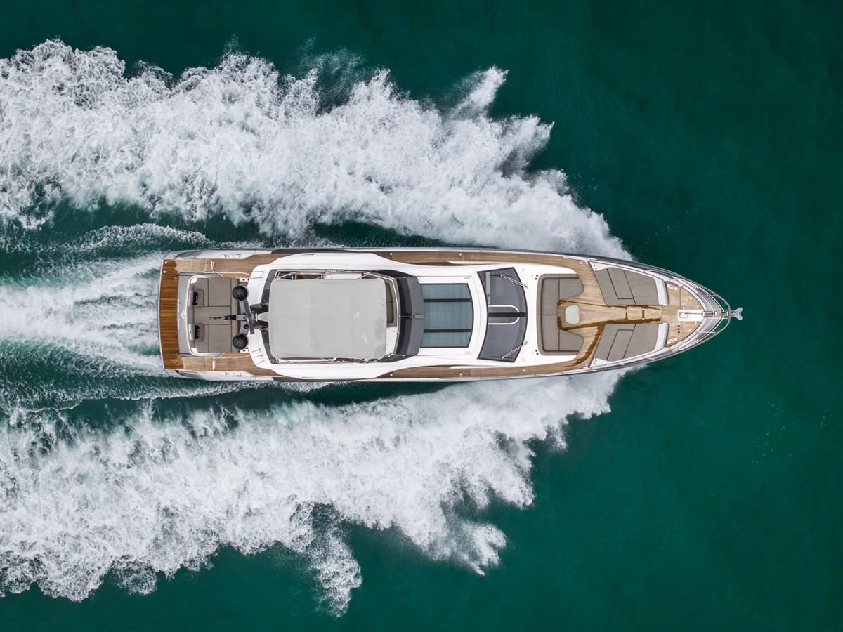 An aerial view of a sleek yacht cruising through the water, showcasing its elegant design and powerful performance. aboard PARTNERSHIP V Yacht for Sale