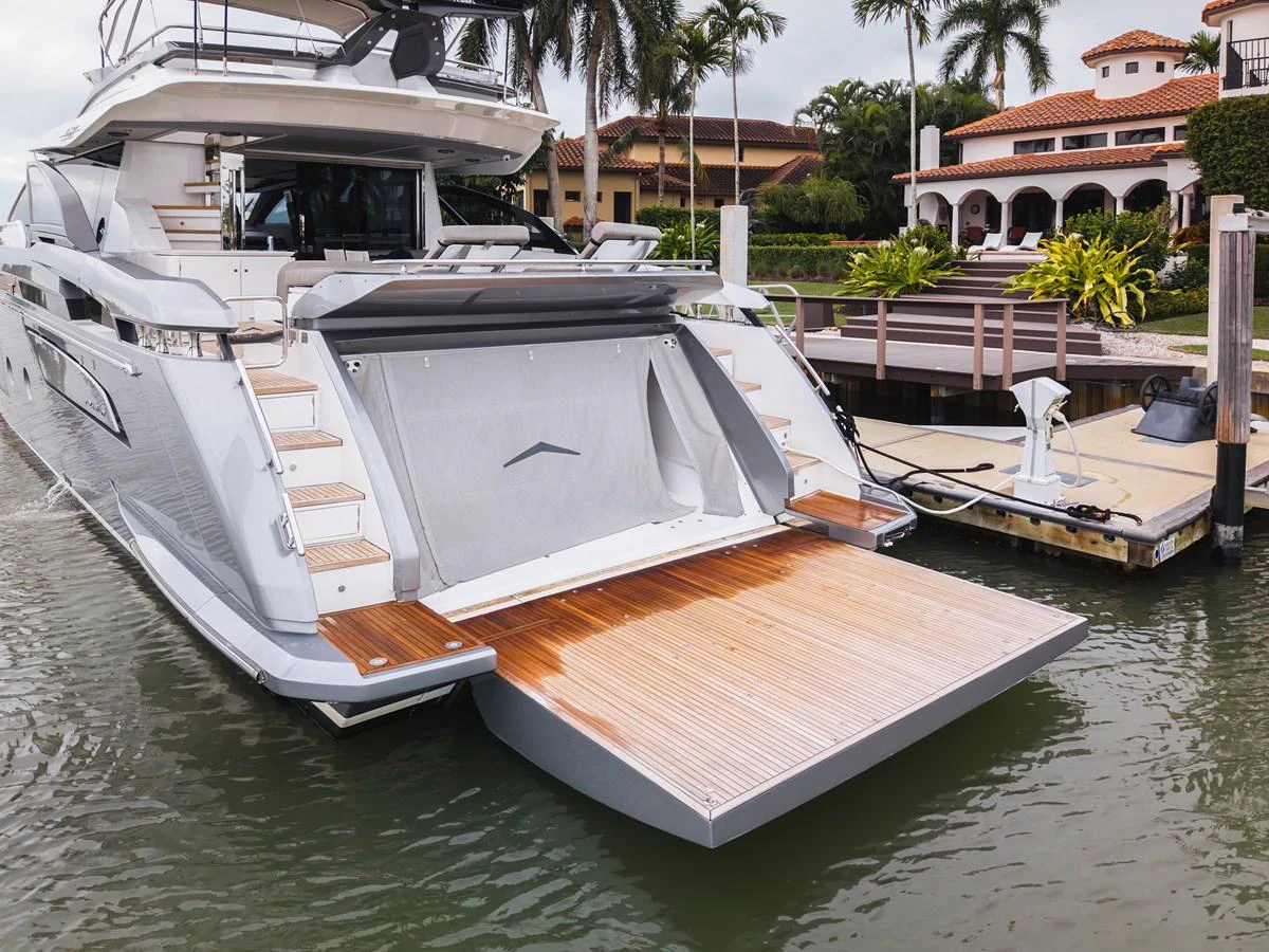 The yacht's aft deck features a spacious swim platform and elegant teak steps, perfect for easy water access. aboard PARTNERSHIP V Yacht for Sale