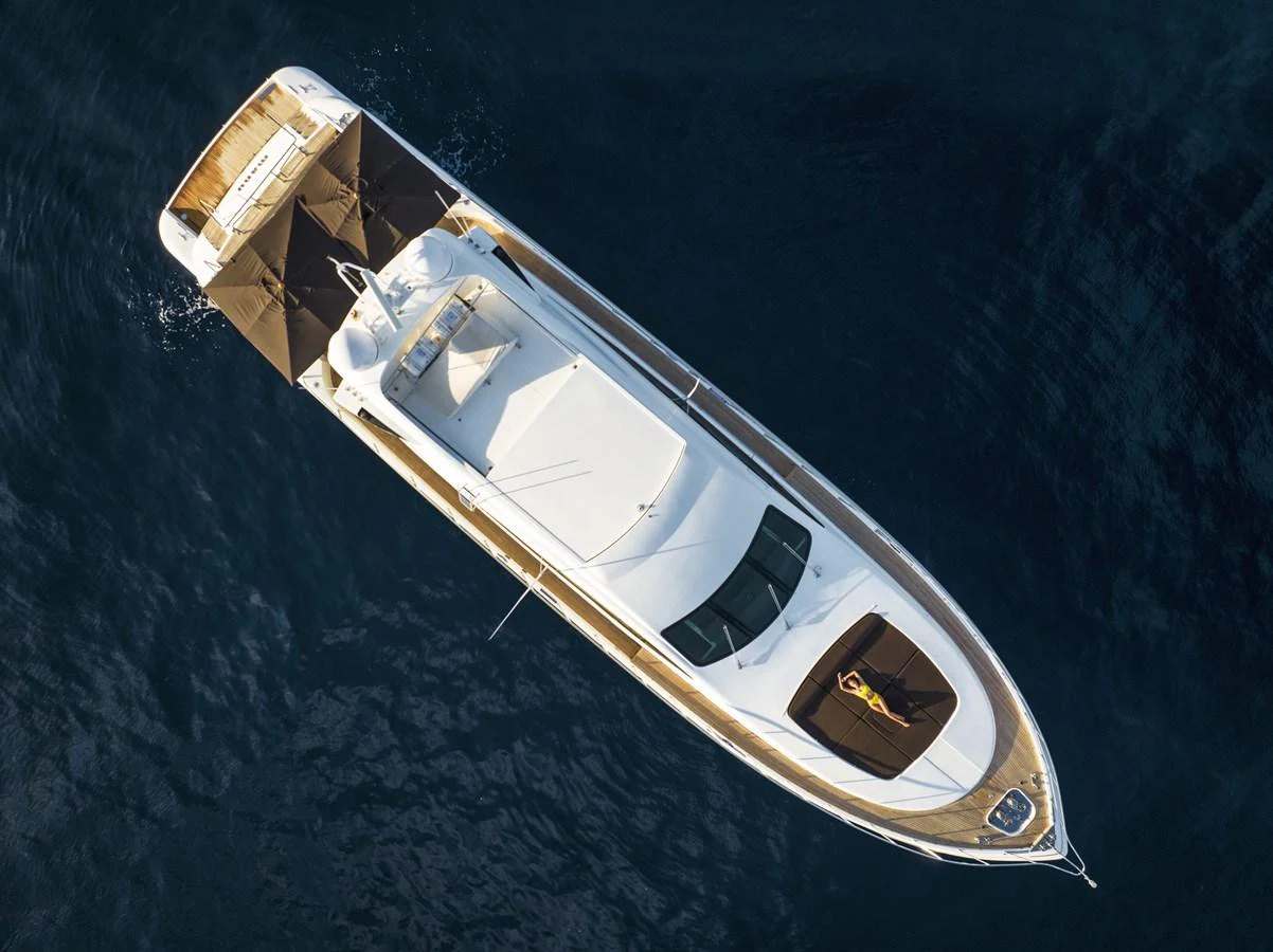 An aerial view of a sleek yacht cruising on calm waters, showcasing its elegant design and spacious deck areas. aboard MANU Yacht for Sale