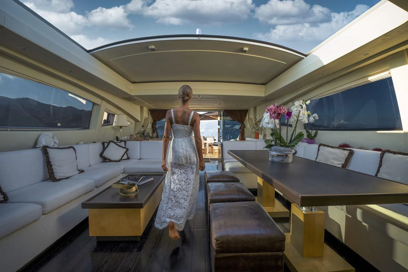 The yacht's salon features elegant seating, a dining area, and large windows for a luxurious and airy ambiance. aboard MANU Yacht for Sale