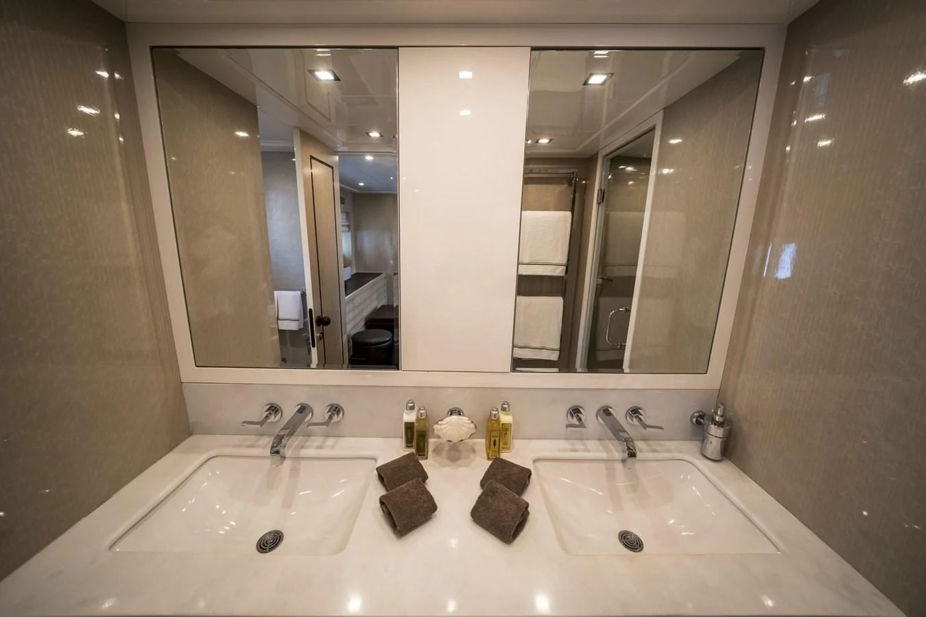 The yacht's bathroom features dual sinks and elegant fixtures. aboard MANU Yacht for Sale