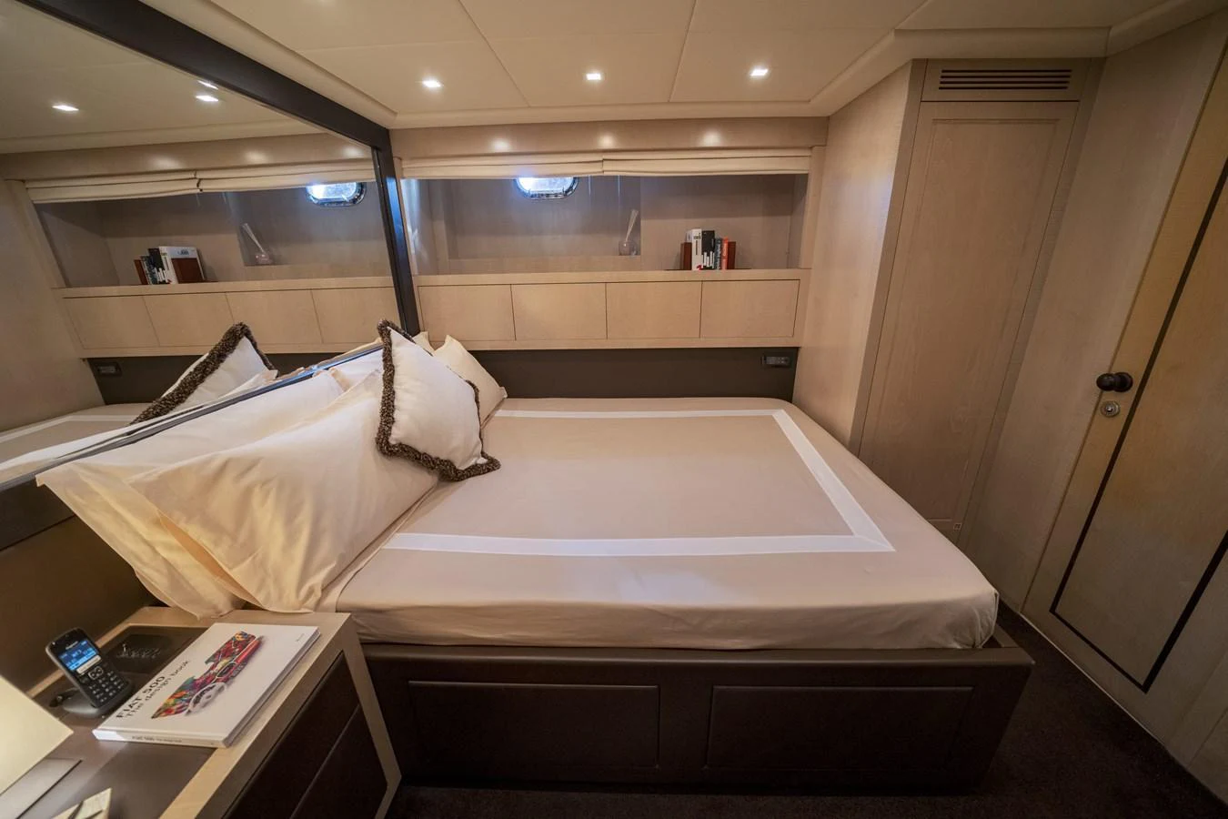 A cozy stateroom featuring a comfortable bed and elegant lighting. aboard MANU Yacht for Sale