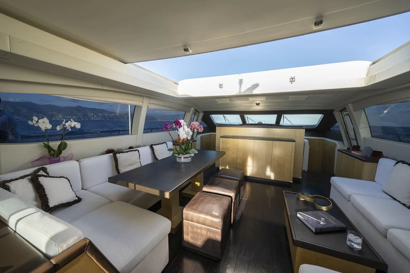 The salon offers a spacious and elegant seating area with panoramic views and modern furnishings. aboard MANU Yacht for Sale
