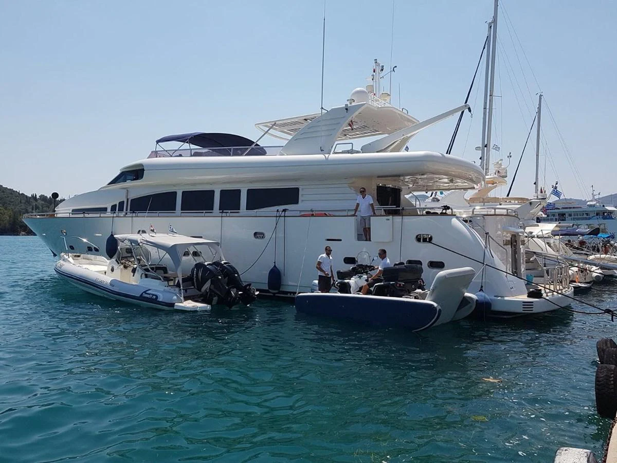 A sleek yacht is docked at a marina, showcasing its elegant design and spacious deck. aboard LADY TATIANA Yacht for Sale
