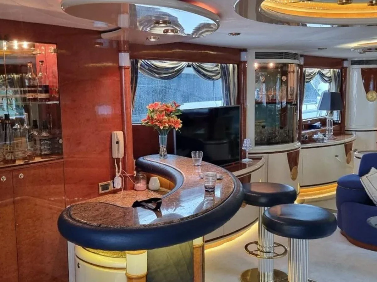 The yacht's saloon features a stylish bar area with luxurious seating and elegant decor. aboard LADY TATIANA Yacht for Sale