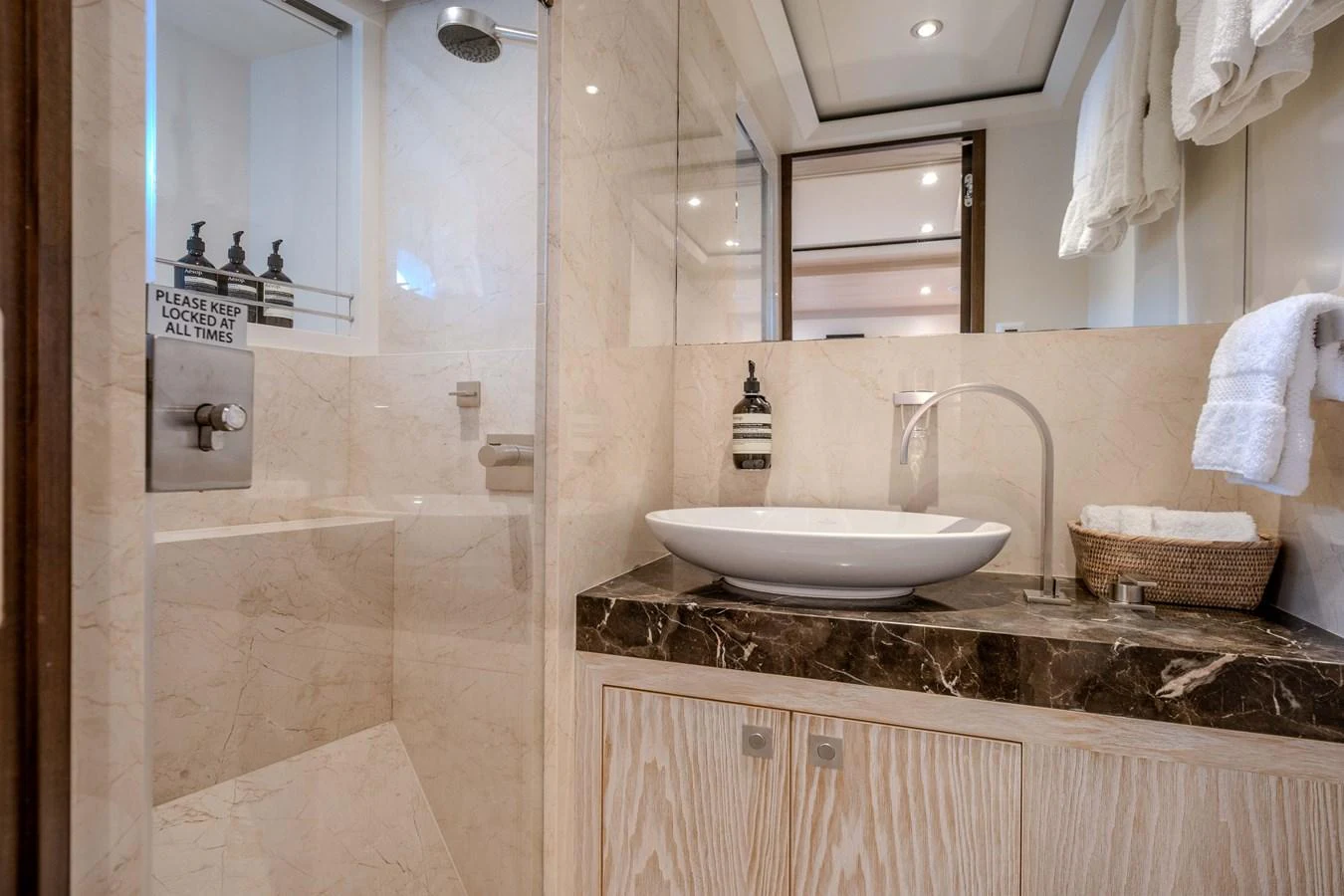 a bathroom with a sink and a mirror aboard MAHALO Yacht for Sale