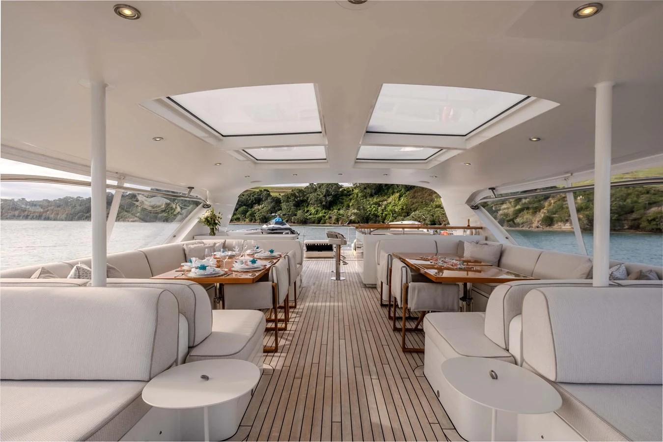 a large room with a table and chairs and a large window aboard MAHALO Yacht for Sale