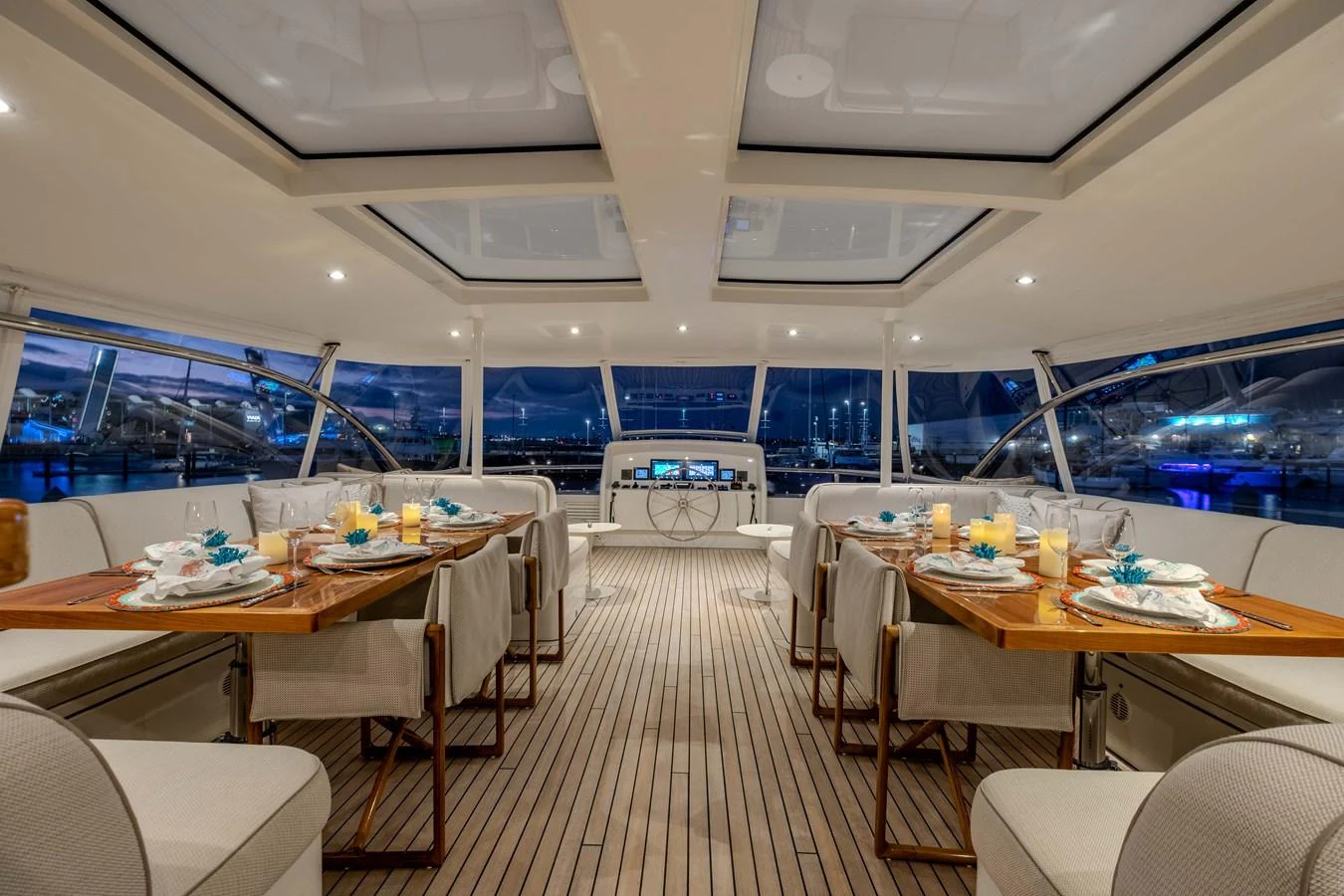 a room with tables and chairs aboard MAHALO Yacht for Sale