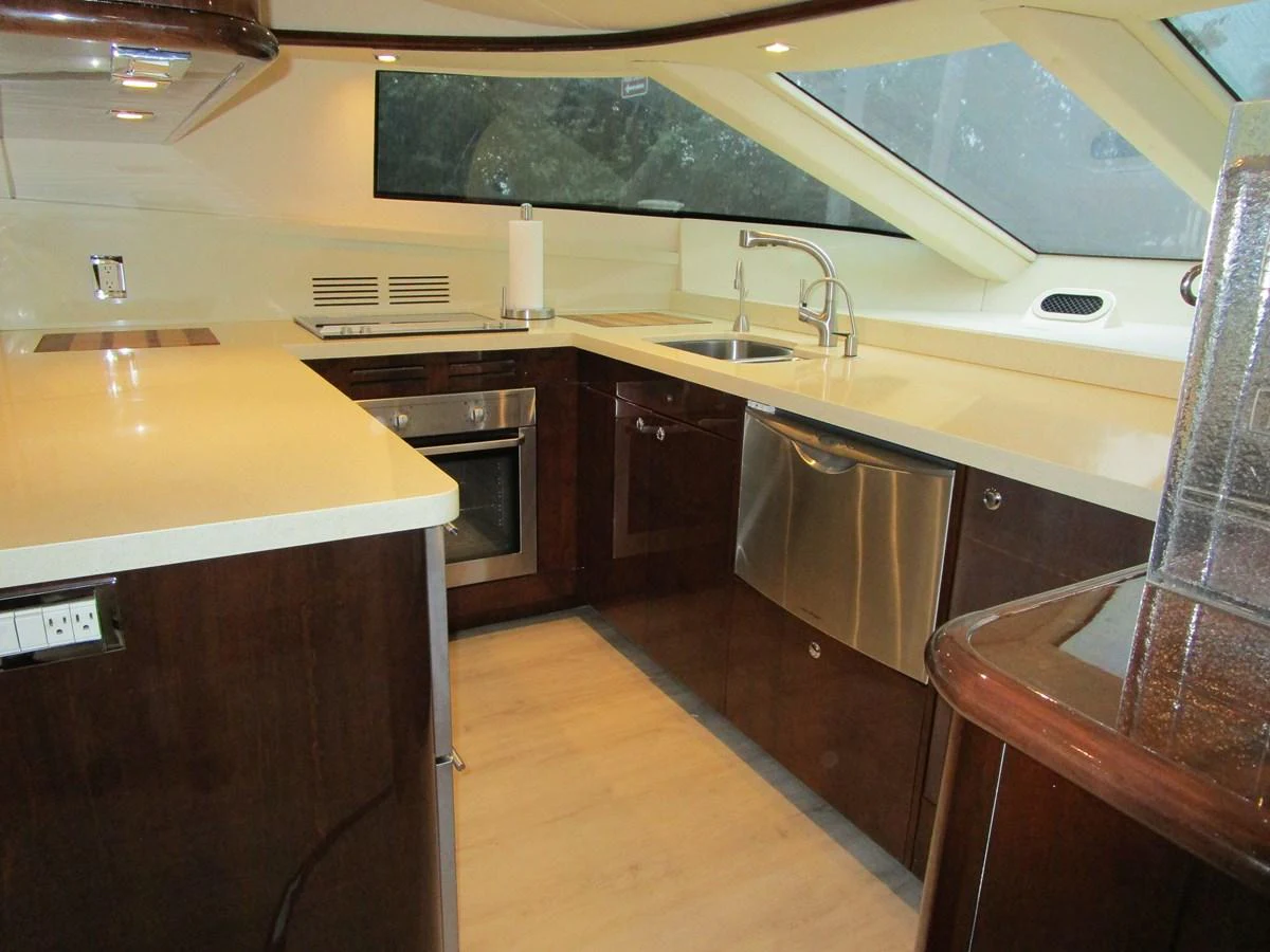 The yacht's galley features modern appliances and ample counter space, creating a sleek and functional cooking area. aboard SHORE GIRL Yacht for Sale