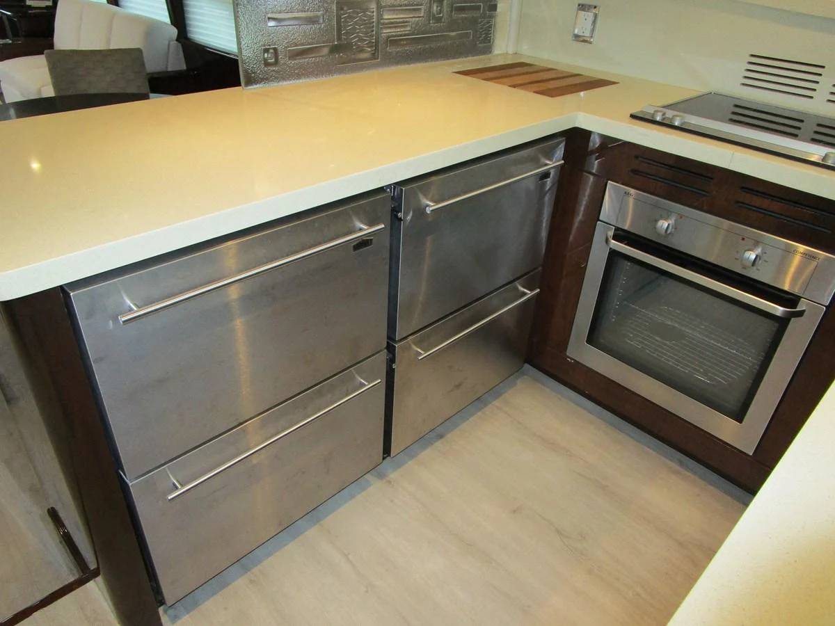 The galley features modern stainless steel appliances and sleek countertops, perfect for gourmet cooking on the water. aboard SHORE GIRL Yacht for Sale