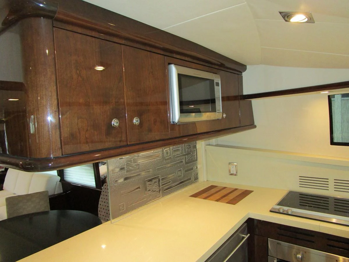 The galley features modern appliances and sleek wooden cabinetry. aboard SHORE GIRL Yacht for Sale