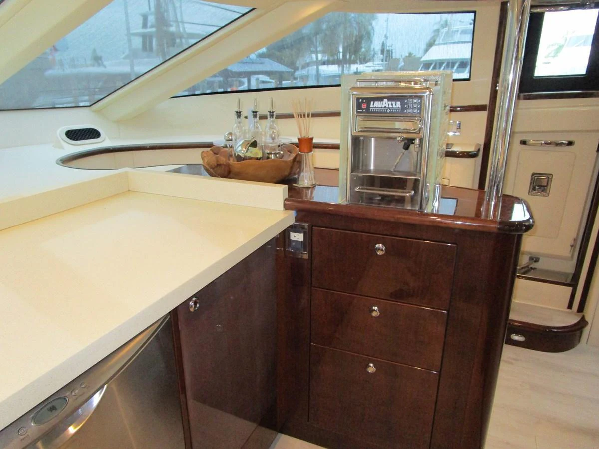 The yacht's galley features a sleek countertop, a coffee machine, and ample storage space. aboard SHORE GIRL Yacht for Sale